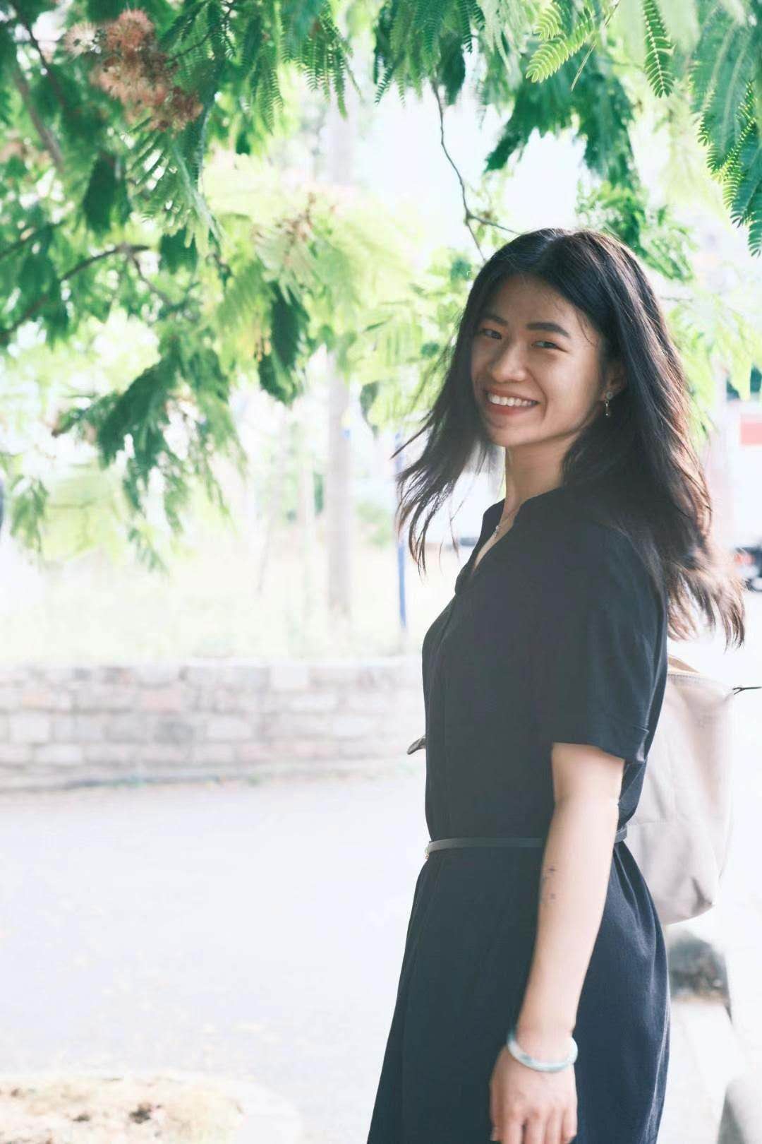 Wendy (Yingdi) Su smiling beneath green trees